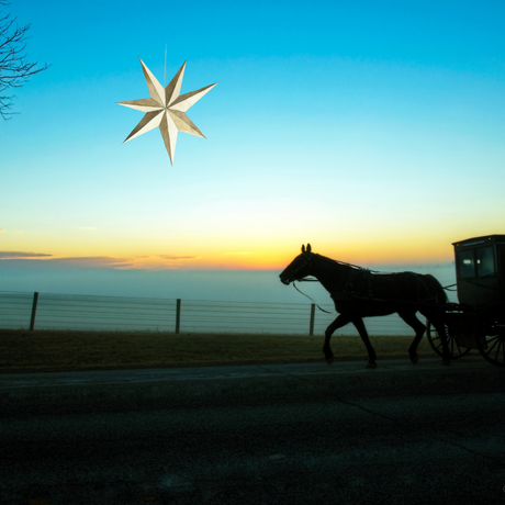 An Amish buggy traveling at dusk